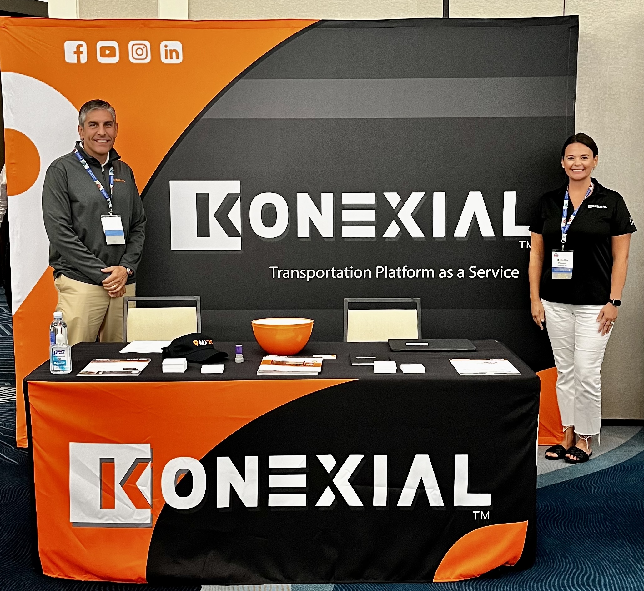 kristin rakoczy and andy dishner in front of Konexial booth