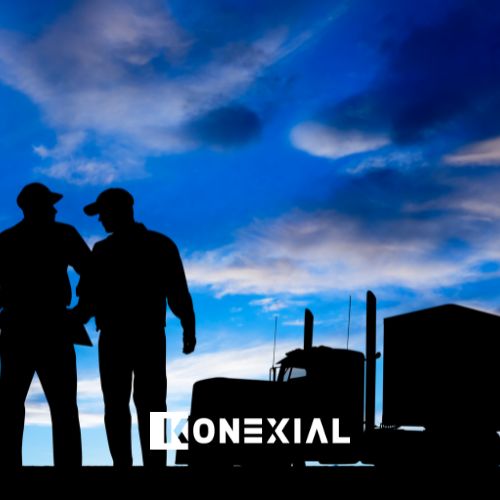 truck drivers talking next to truck in the evening