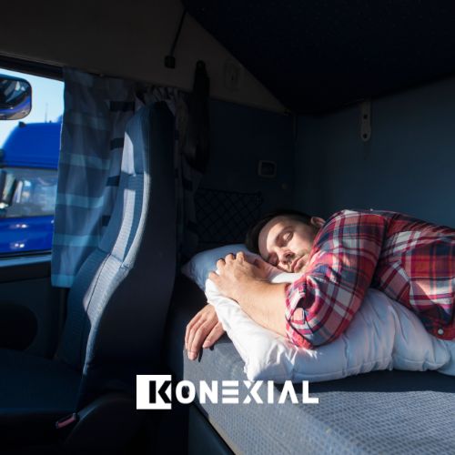 Male truck driver sleeping in the sleeper berth compartment of their unit